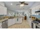 Bright kitchen with breakfast bar, granite countertops, stainless dishwasher, and wood flooring at 3728 Egret Dunes Dr, Ormond Beach, FL 32176