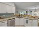 Kitchen with stainless steel dishwasher, wooden breakfast bar, and light tile backsplash at 3728 Egret Dunes Dr, Ormond Beach, FL 32176