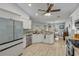 Open-concept kitchen with white cabinets, stainless appliances, and adjacent dining area at 3728 Egret Dunes Dr, Ormond Beach, FL 32176