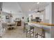 Bright kitchen with white cabinets, stainless appliances, breakfast bar, and dining area at 3728 Egret Dunes Dr, Ormond Beach, FL 32176
