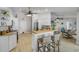 Open-concept kitchen featuring white cabinetry, a breakfast bar, and a view into the living area at 3728 Egret Dunes Dr, Ormond Beach, FL 32176
