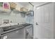 Well-equipped laundry room with modern washer and dryer, plus shelving and storage baskets, is designed for convenience at 3728 Egret Dunes Dr, Ormond Beach, FL 32176