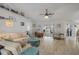 Open living room with vaulted ceiling, a ceiling fan, and sliding glass doors to the lanai and pool at 3728 Egret Dunes Dr, Ormond Beach, FL 32176