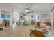 Spacious living room with wood-look tile flooring and light colored walls and furnishings at 3728 Egret Dunes Dr, Ormond Beach, FL 32176