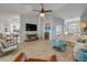 Large living room open to the kitchen with wood-look tile flooring, a ceiling fan, and comfortable seating at 3728 Egret Dunes Dr, Ormond Beach, FL 32176