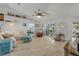 Cozy living room with neutral tones, wood-look floors, and access to the outdoor patio and pool area at 3728 Egret Dunes Dr, Ormond Beach, FL 32176