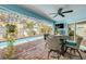 A screened pool with a covered patio featuring a dining set and a ceiling fan, offering a relaxed outdoor space at 3728 Egret Dunes Dr, Ormond Beach, FL 32176
