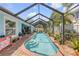 A private screened pool is framed by a brick patio and mature landscaping, creating a serene backyard oasis at 3728 Egret Dunes Dr, Ormond Beach, FL 32176