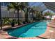 Enclosed pool with brick deck and mature tropical landscaping at 3728 Egret Dunes Dr, Ormond Beach, FL 32176