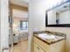 Bathroom with a vanity and mirror, with view to a well lit bedroom at 3800 Saxon Dr # 250, New Smyrna Beach, FL 32169