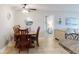 Cozy dining room with wooden table and a peek into the living room and bedroom at 3800 Saxon Dr # 250, New Smyrna Beach, FL 32169