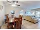 Bright open-concept living and dining area with tile floors and neutral paint at 3800 Saxon Dr # 250, New Smyrna Beach, FL 32169