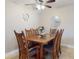 Dining room with a six-seat wooden table and lovely decor at 3800 Saxon Dr # 250, New Smyrna Beach, FL 32169