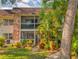 Charming condo building with beautiful landscaping and a screened balcony, creating a welcoming outdoor space at 3800 Saxon Dr # 250, New Smyrna Beach, FL 32169