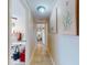 Bright hallway with tile floors, leading to a bedroom with artwork and natural light at 3800 Saxon Dr # 250, New Smyrna Beach, FL 32169