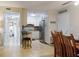 Well-lit kitchen with white cabinets, stainless steel appliances, and tile flooring, open to the dining area at 3800 Saxon Dr # 250, New Smyrna Beach, FL 32169