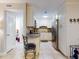Efficient kitchen featuring white cabinets, stainless steel fridge, and breakfast bar at 3800 Saxon Dr # 250, New Smyrna Beach, FL 32169