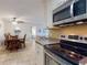 Well-lit kitchen with stainless steel appliances, granite counters, and open floor plan at 3800 Saxon Dr # 250, New Smyrna Beach, FL 32169