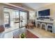 Light and airy living room featuring large windows and a desk area at 3800 Saxon Dr # 250, New Smyrna Beach, FL 32169