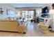 Living room with beige leather sofa and large sliding glass doors at 3800 Saxon Dr # 250, New Smyrna Beach, FL 32169