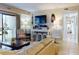 Comfortable living room with neutral tones, a cozy sofa, a TV, and a view to the outdoors at 3800 Saxon Dr # 250, New Smyrna Beach, FL 32169