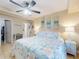 Inviting bedroom with a king-size bed, coastal-themed decor, and ensuite bathroom access at 3800 Saxon Dr # 250, New Smyrna Beach, FL 32169