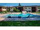 Attractive community pool surrounded by green lawns and tropical foliage provides a refreshing amenity at 3800 Saxon Dr # 250, New Smyrna Beach, FL 32169