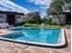 Inviting community pool with surrounding lounge chairs and tables, perfect for relaxation and socializing at 3800 Saxon Dr # 250, New Smyrna Beach, FL 32169