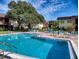 Large community pool surrounded by lush greenery, offering a tranquil retreat for residents at 3800 Saxon Dr # 250, New Smyrna Beach, FL 32169