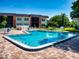 Refreshing community pool with ample seating and manicured landscaping, creating a serene oasis at 3800 Saxon Dr # 250, New Smyrna Beach, FL 32169