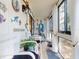 Enclosed porch decorated in a beachy theme with seating, plants, and wall decor at 3800 Saxon Dr # 250, New Smyrna Beach, FL 32169