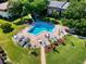 Community swimming pool with lounge chairs at 3800 Saxon Dr # 250, New Smyrna Beach, FL 32169