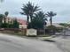 Entrance to Tuscany Square Condominiums with palm trees and lush landscaping at 424 Luna Bella Ln # 226, New Smyrna Beach, FL 32168