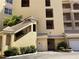 Elegant condo building with multiple floors, balconies, and well-maintained landscaping at 424 Luna Bella Ln # 226, New Smyrna Beach, FL 32168