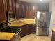 Kitchen features dark wood cabinets, stainless steel appliances and stone countertops at 424 Luna Bella Ln # 226, New Smyrna Beach, FL 32168