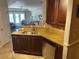 Kitchen features dark wood cabinets, stainless steel appliances and stone countertops at 424 Luna Bella Ln # 226, New Smyrna Beach, FL 32168
