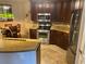 Kitchen features dark wood cabinets, stainless steel appliances and stone countertops at 424 Luna Bella Ln # 226, New Smyrna Beach, FL 32168