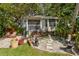 Charming cottage-style home with waterfront access and a lush, tropical backyard setting at 4426 Saxon Dr, New Smyrna Beach, FL 32169