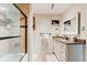 Bathroom with a shower-tub combo, granite vanity, and neutral tile floors at 4426 Saxon Dr, New Smyrna Beach, FL 32169