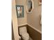 Cozy bathroom with toilet, wall mirror and shelving at 4426 Saxon Dr, New Smyrna Beach, FL 32169