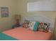 Inviting bedroom with a comfy bed, bright accents, and natural light from the window at 4426 Saxon Dr, New Smyrna Beach, FL 32169