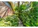 Lush landscaping surrounds this charming brick home, creating a serene, private setting at 4426 Saxon Dr, New Smyrna Beach, FL 32169
