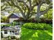 Charming home with mature trees, colorful landscaping, and well-maintained lawn at 4426 Saxon Dr, New Smyrna Beach, FL 32169