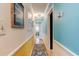 Hallway with hardwood floors, decorative artwork, and access to multiple rooms at 4426 Saxon Dr, New Smyrna Beach, FL 32169