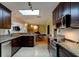 Kitchen with granite counters and stainless steel appliances, opening to dining area at 4426 Saxon Dr, New Smyrna Beach, FL 32169