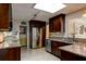 Well-lit kitchen featuring stainless steel appliances, granite countertops, and modern dark wood cabinetry at 4426 Saxon Dr, New Smyrna Beach, FL 32169