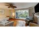 Living room with hardwood floors, large windows with a view to the back yard at 4426 Saxon Dr, New Smyrna Beach, FL 32169