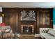 Inviting living room with a decorative fireplace and custom built-in dark wood cabinetry at 4426 Saxon Dr, New Smyrna Beach, FL 32169
