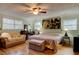 A spacious main bedroom featuring a ceiling fan, and a large window for natural light at 4426 Saxon Dr, New Smyrna Beach, FL 32169