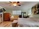 A spacious main bedroom featuring a ceiling fan, and a large window for natural light at 4426 Saxon Dr, New Smyrna Beach, FL 32169
